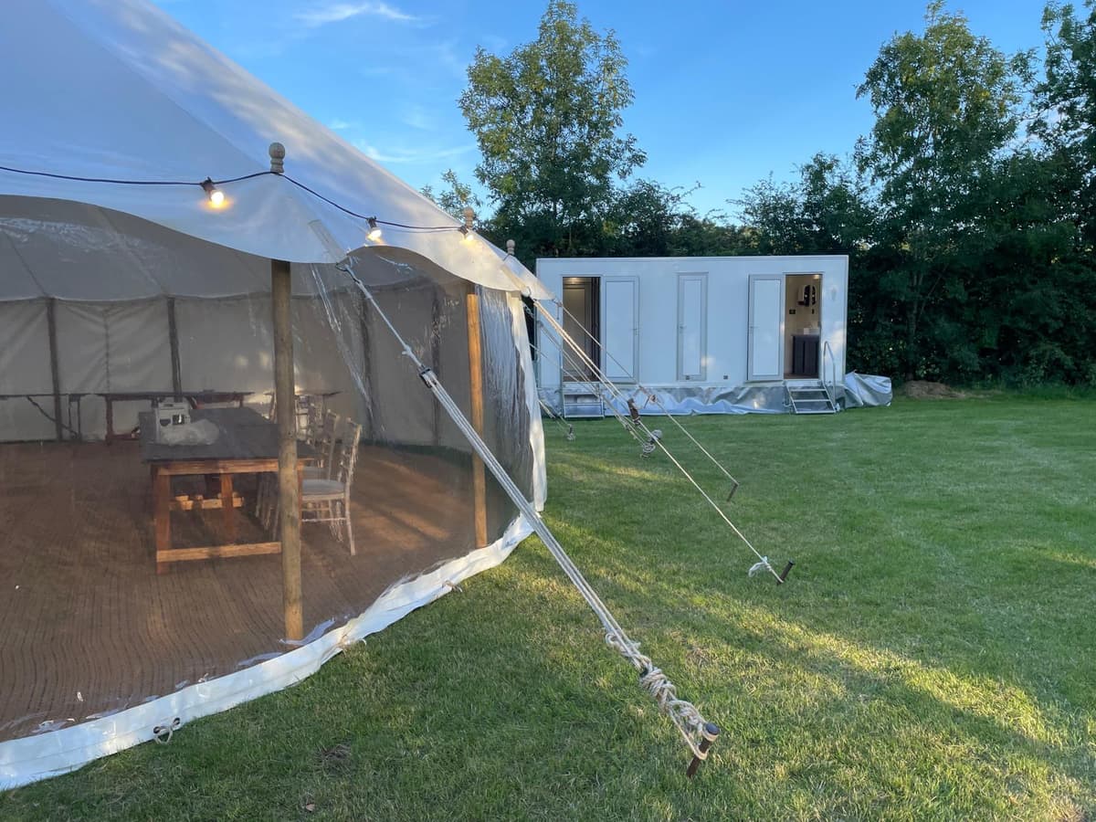 Luxury trailer alongside marquee at event