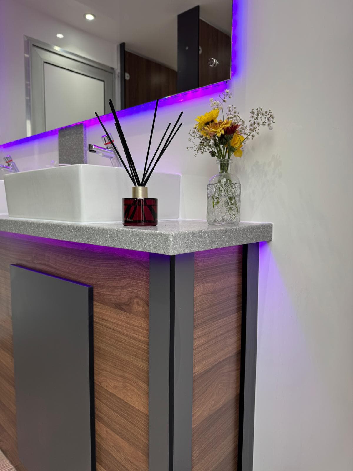 Granite vanity basin with purple LED and flowers