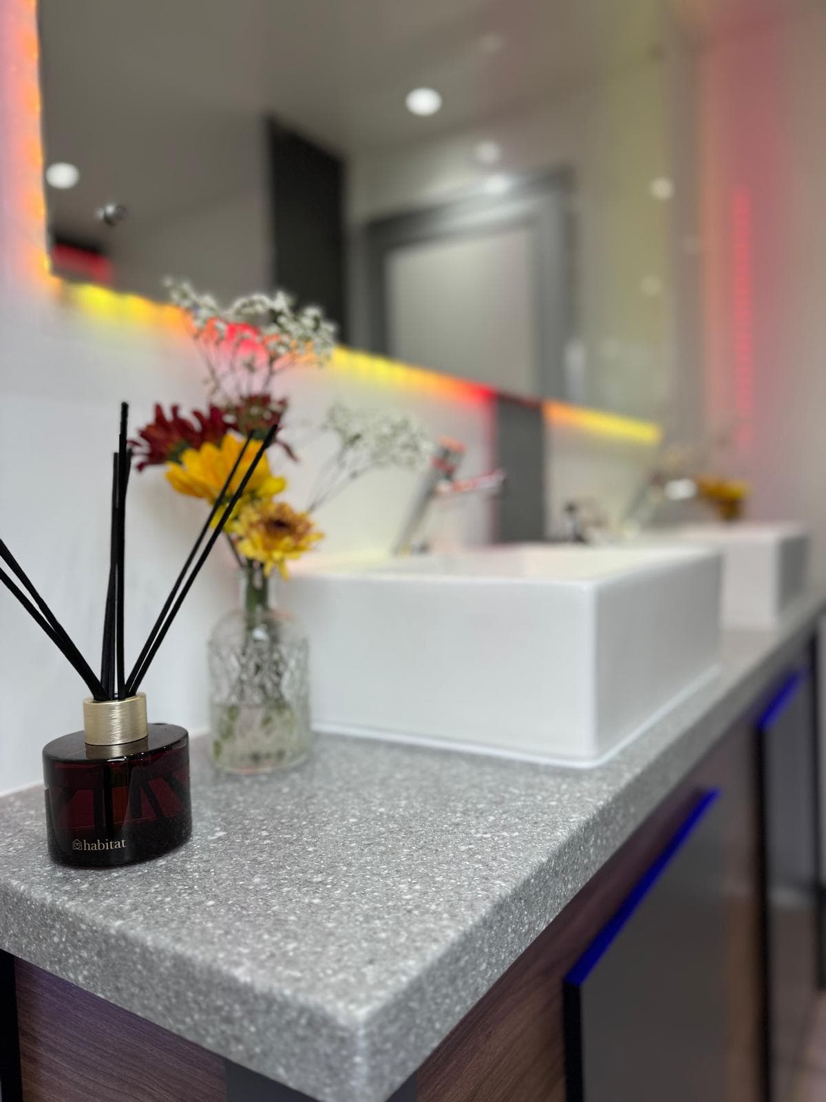 Vanity close-up with reed diffuser and flowers