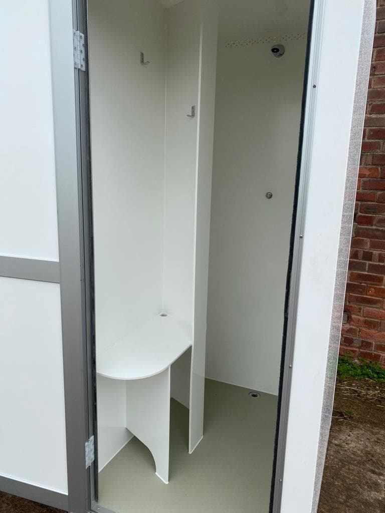 Portable shower interior with shelf, hooks and shower head
