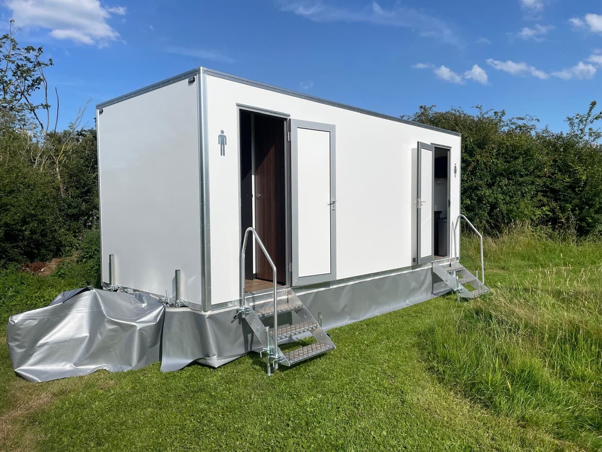 Luxury toilet trailer exterior in field setting